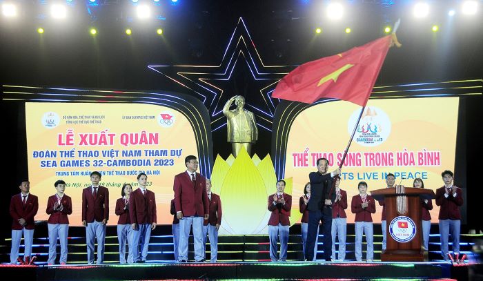 Phó Thủ tướng Chính phủ Lê Minh Khái trao cờ Tổ quốc cho Trưởng đoàn Thể thao Việt Nam tại SEA Games 32 Đặng Hà Việt.